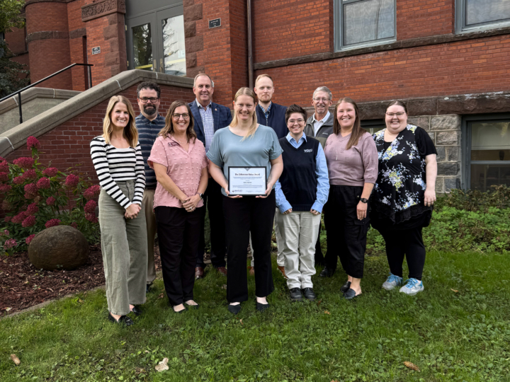 Kelly Spanier receiving award from colleagues