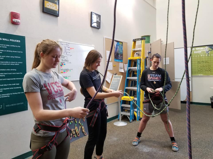 students preparing for the rock climbing wall