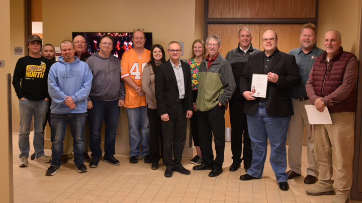 Stephen Langved receiving award from colleagues