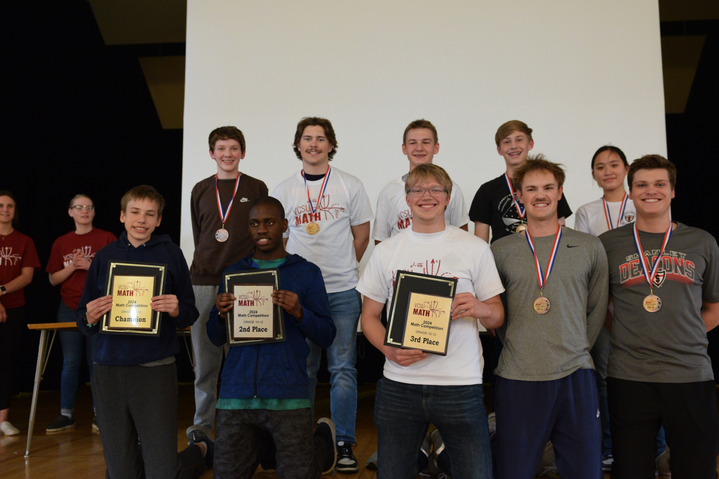 Award winners pose for a photo with their plaques