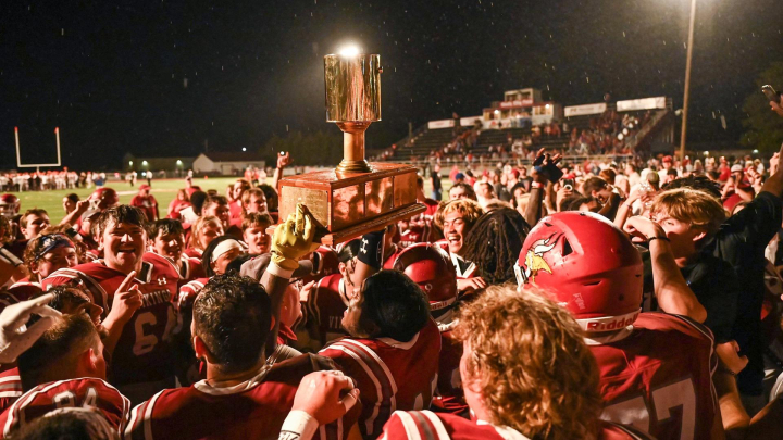football team celebrating win with Paint Bucket Trophy
