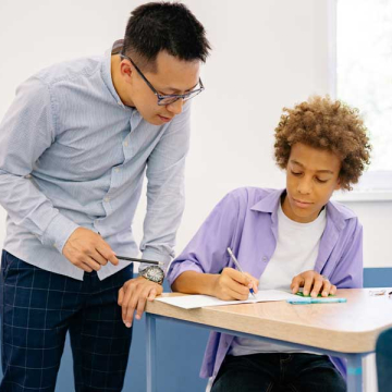 A teacher speaks with a student.